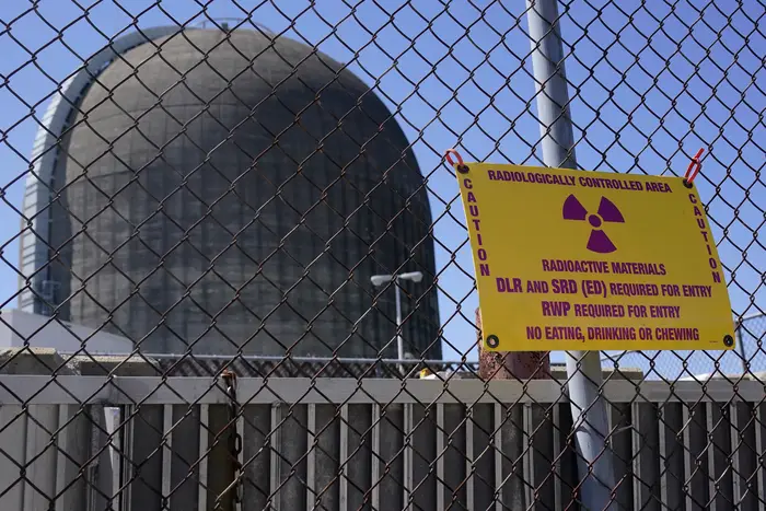 Sign warning of radioactive materials is seen on a fence around a containment building at at Indian Point Energy Center in Buchanan, New York, April 26, 2021.